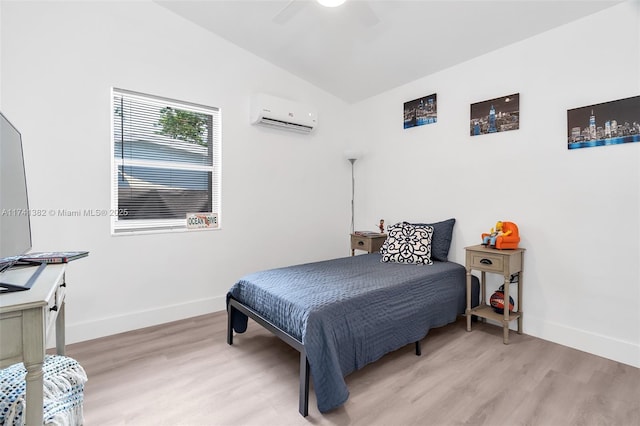 658 SW 1st Ct, Boynton Beach, FL 33426 - bedroom featuring a wall mounted air conditioner, light wood-style floors, lofted ceiling, and a ceiling fan