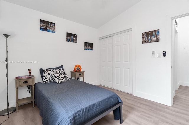 658 SW 1st Ct, Boynton Beach, FL 33426 - bedroom featuring light wood finished floors, a closet, and lofted ceiling