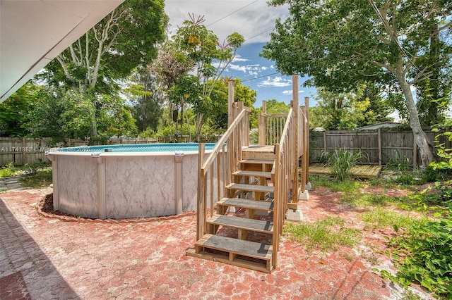 658 SW 1st Ct, Boynton Beach, FL 33426 - view of swimming pool featuring stairway, a fenced backyard, and a wooden deck