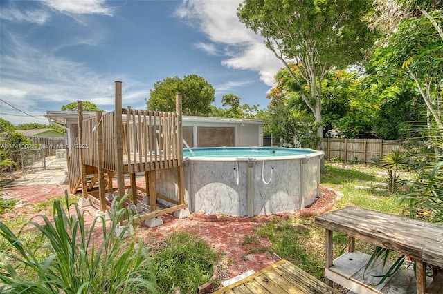 658 SW 1st Ct, Boynton Beach, FL 33426 - view of swimming pool featuring a fenced backyard and a deck