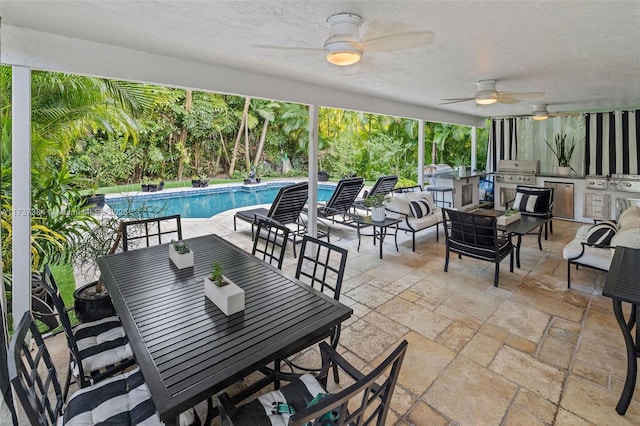 view of patio with grilling area, area for grilling, and ceiling fan