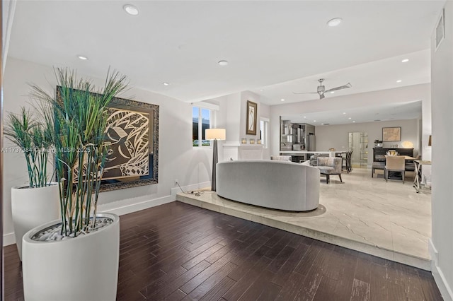 living room featuring ceiling fan and hardwood / wood-style floors