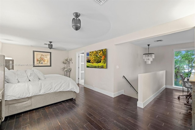 bedroom featuring dark hardwood / wood-style floors and a chandelier