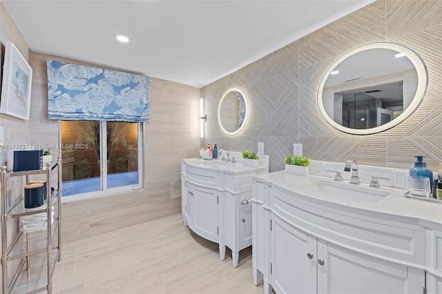 bathroom featuring tile walls and vanity