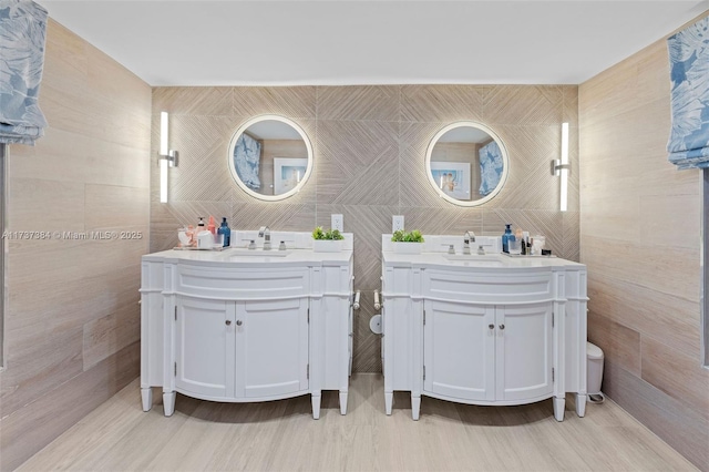 bathroom featuring tile walls and vanity