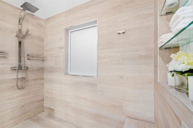 bathroom with a tile shower