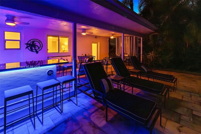 view of patio / terrace with ceiling fan and a swimming pool