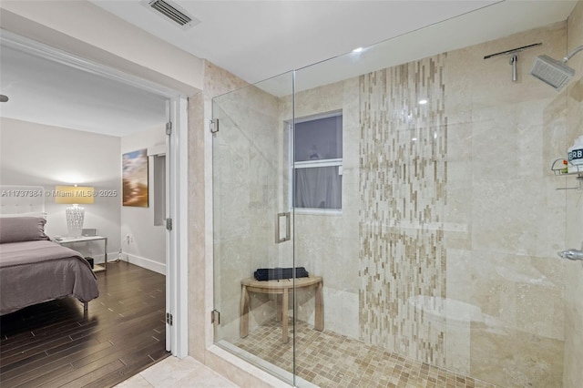 bathroom featuring hardwood / wood-style flooring and an enclosed shower