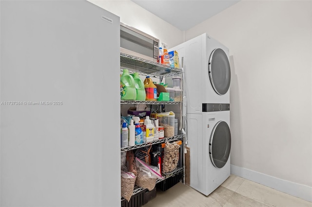 washroom featuring stacked washer / drying machine