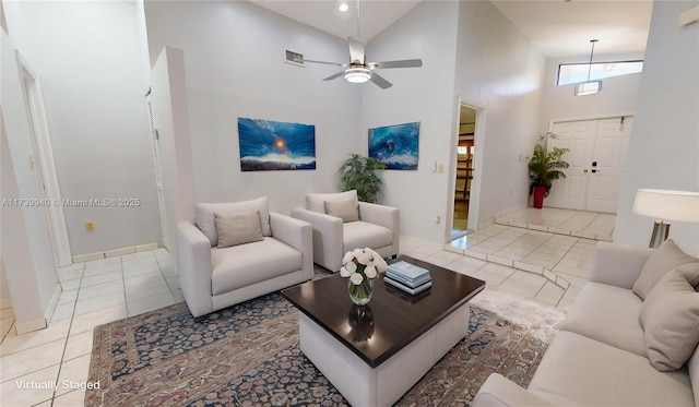 tiled living room featuring a towering ceiling and ceiling fan