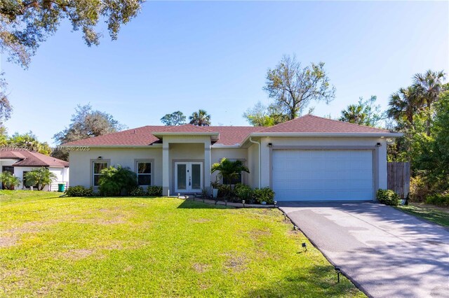 3302 Desoto Blvd S, Naples, FL 34117 - view of front facade featuring a garage, stucco siding, a front yard, and french doors