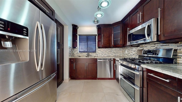 kitchen with sink, decorative backsplash, and stainless steel appliances