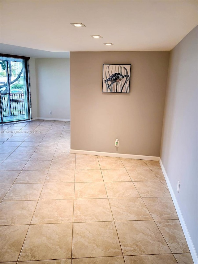 unfurnished room with light tile patterned floors, baseboards, and recessed lighting