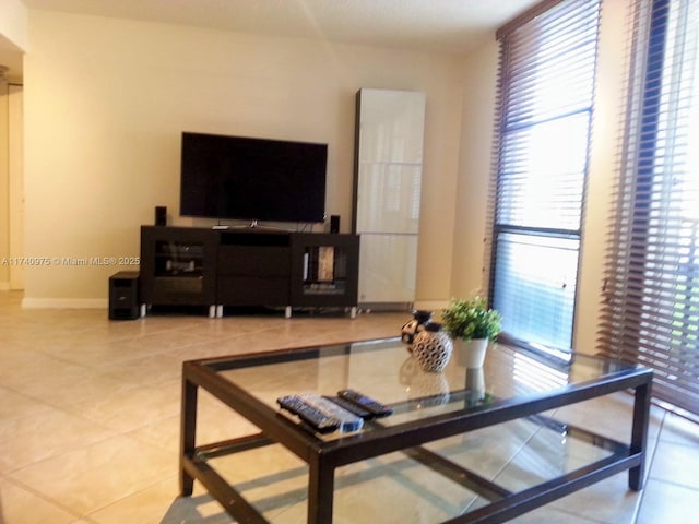 tiled living area featuring baseboards