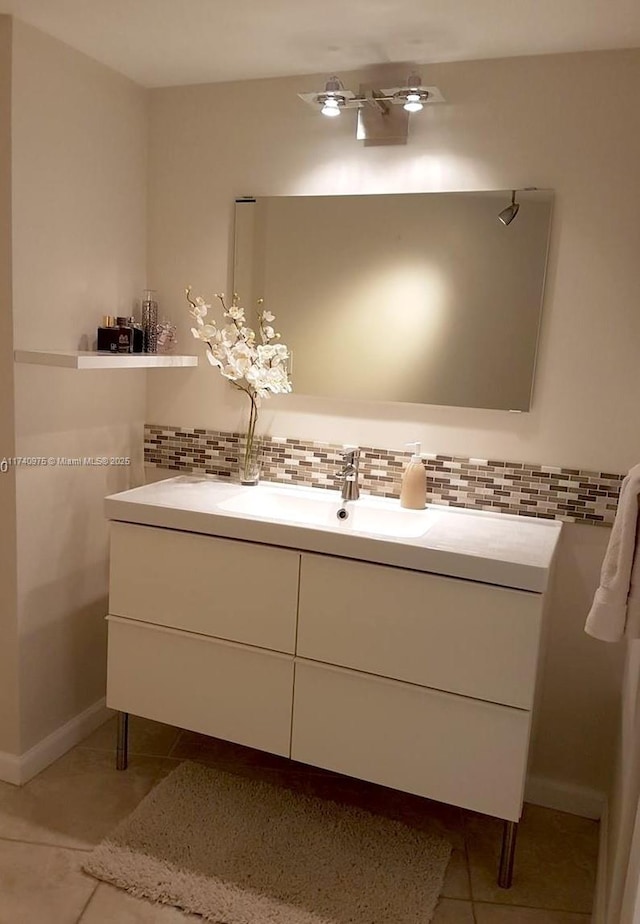 bathroom featuring tile patterned flooring, vanity, and backsplash