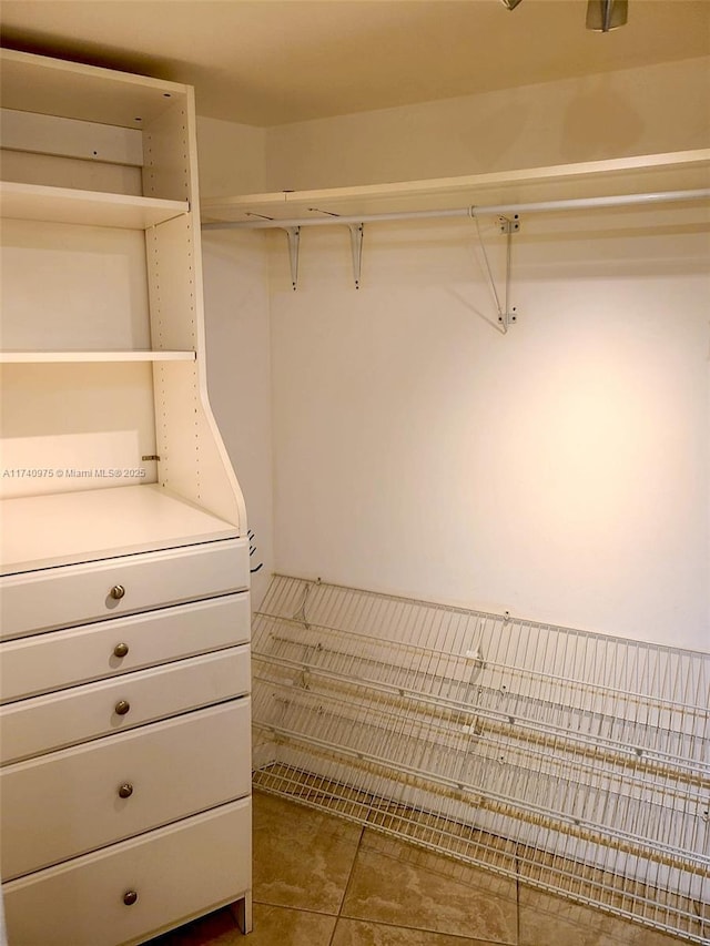 spacious closet featuring tile patterned flooring