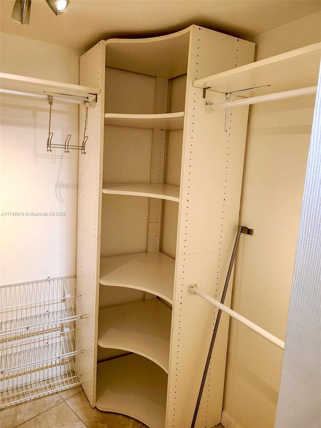 walk in closet with tile patterned flooring