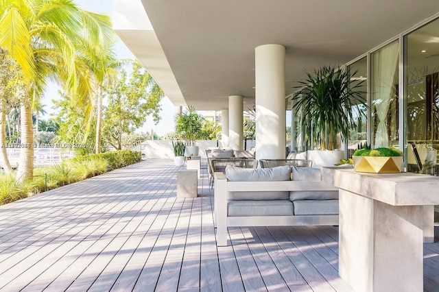 view of patio / terrace featuring a wooden deck, an outdoor kitchen, and an outdoor hangout area