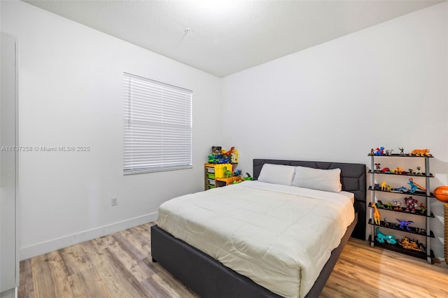 bedroom with hardwood / wood-style floors