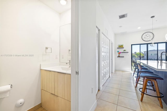 bathroom with tile patterned flooring and sink