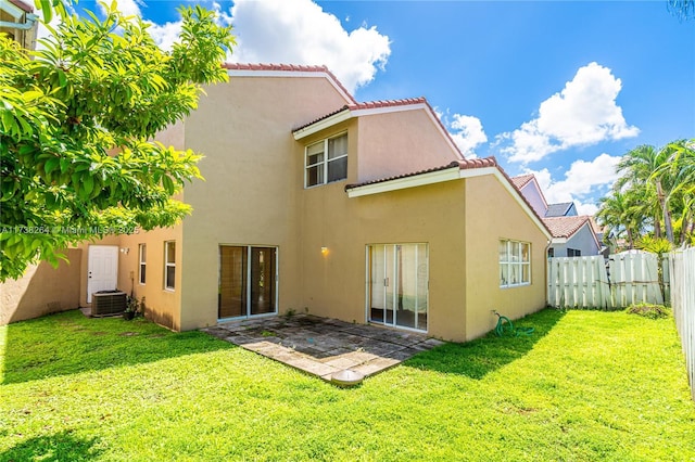 back of house with a patio, a yard, stucco siding, a fenced backyard, and a tiled roof