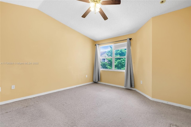 carpeted empty room with lofted ceiling, ceiling fan, a textured ceiling, and baseboards