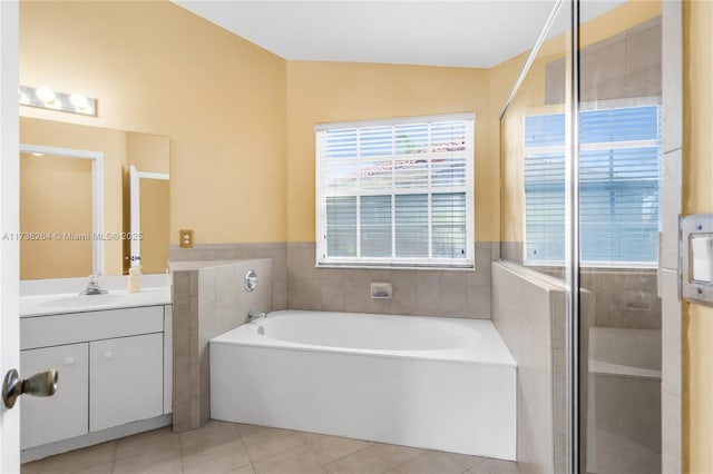 bathroom featuring a bath, a shower stall, vanity, and tile patterned floors