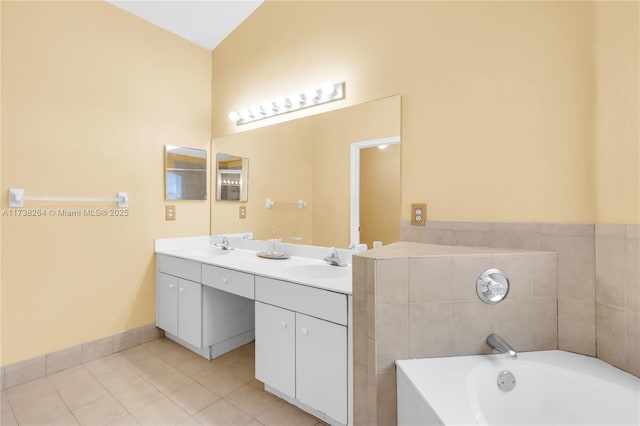 full bathroom with double vanity, a garden tub, tile patterned flooring, and a sink