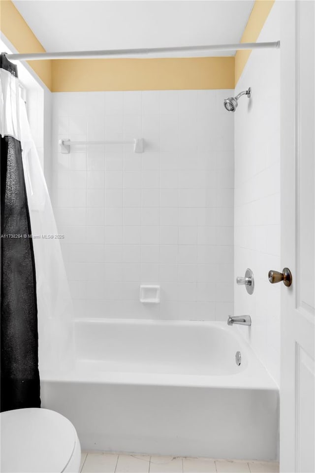 bathroom with shower / bath combo, toilet, and tile patterned floors