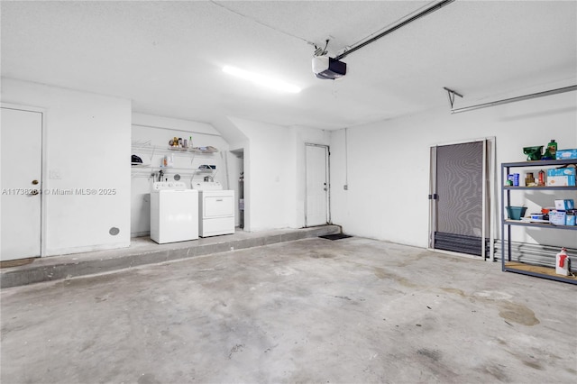 garage featuring independent washer and dryer and a garage door opener