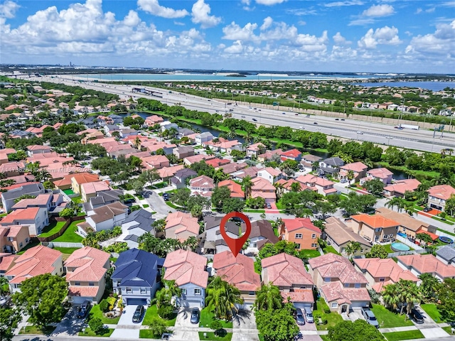 bird's eye view featuring a water view and a residential view