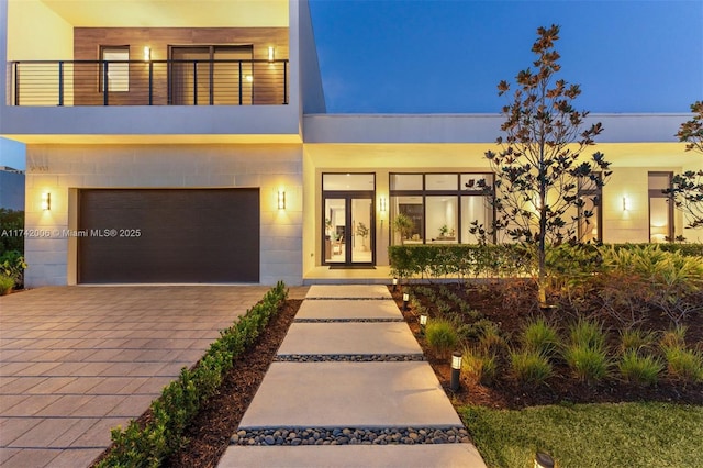 contemporary house with a balcony and a garage