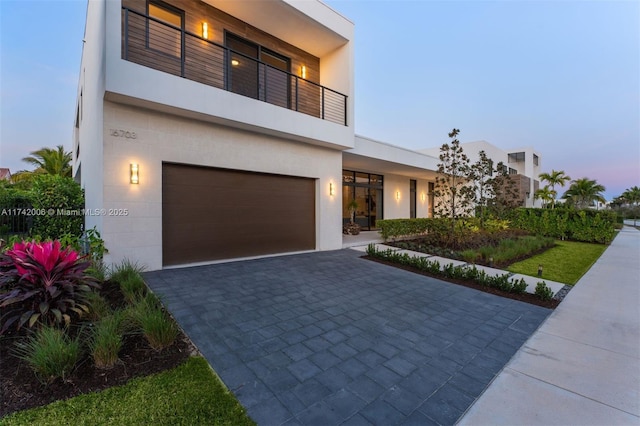 contemporary house featuring a balcony and a garage