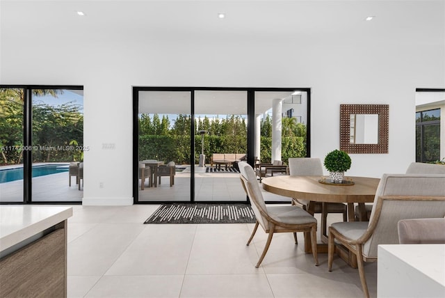 dining room featuring light tile patterned flooring and plenty of natural light