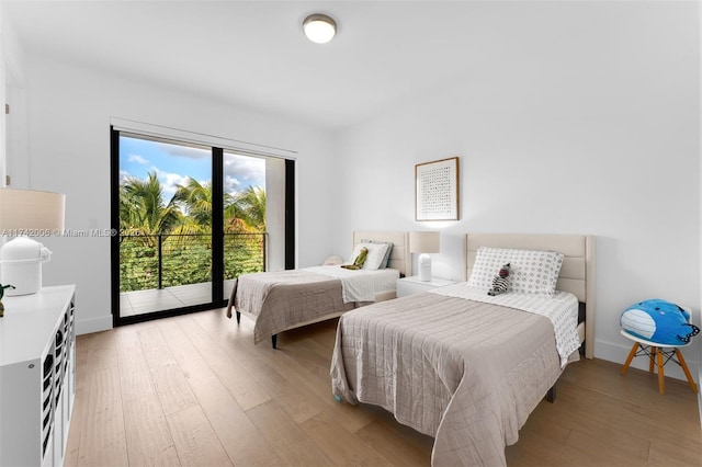 bedroom featuring access to outside and light hardwood / wood-style flooring