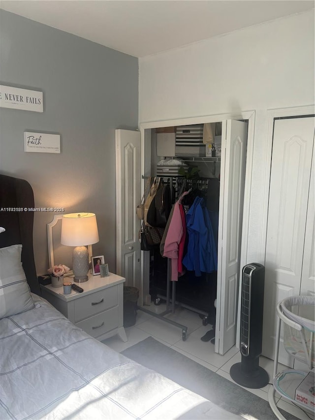 tiled bedroom featuring two closets