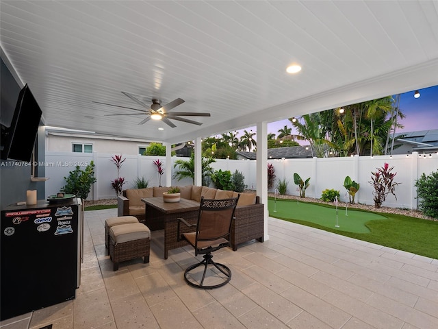 patio terrace at dusk with ceiling fan and outdoor lounge area