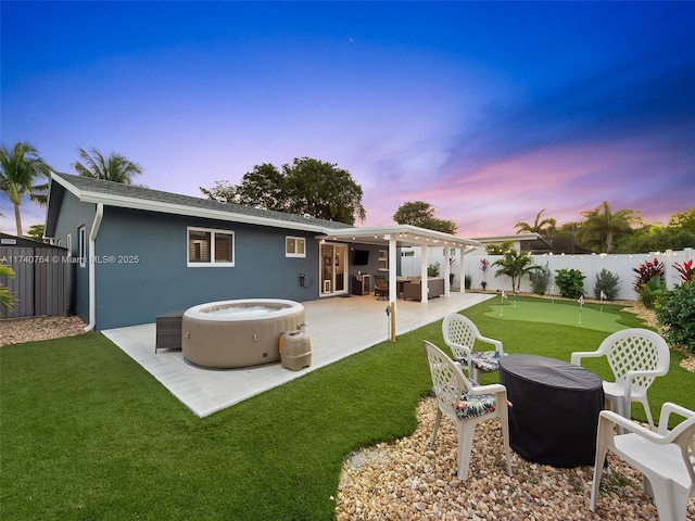 back house at dusk featuring a patio area