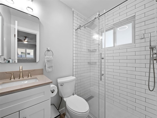 bathroom with vanity, toilet, and a shower with shower door