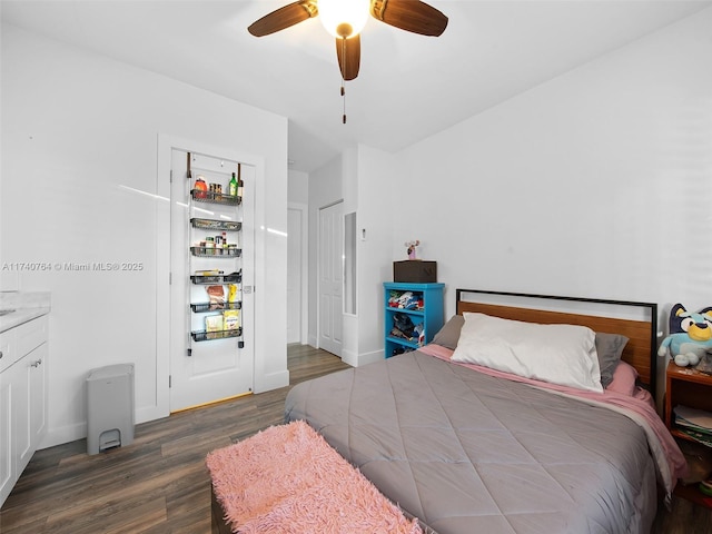 bedroom with dark hardwood / wood-style flooring and ceiling fan