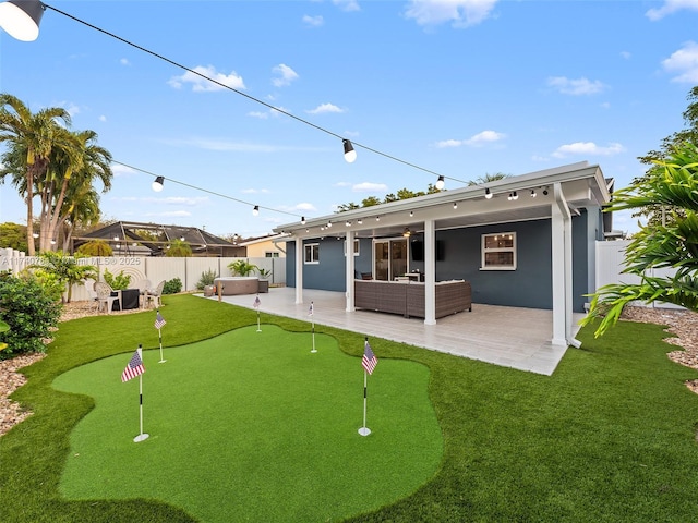 rear view of house with a hot tub, outdoor lounge area, ceiling fan, and a patio area