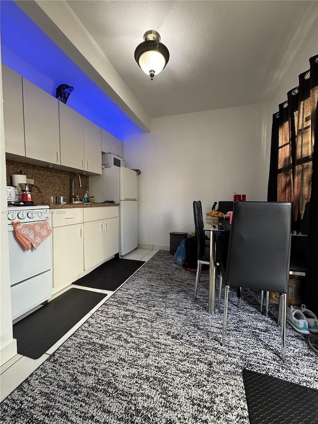 kitchen with tile patterned flooring, sink, white appliances, and tasteful backsplash