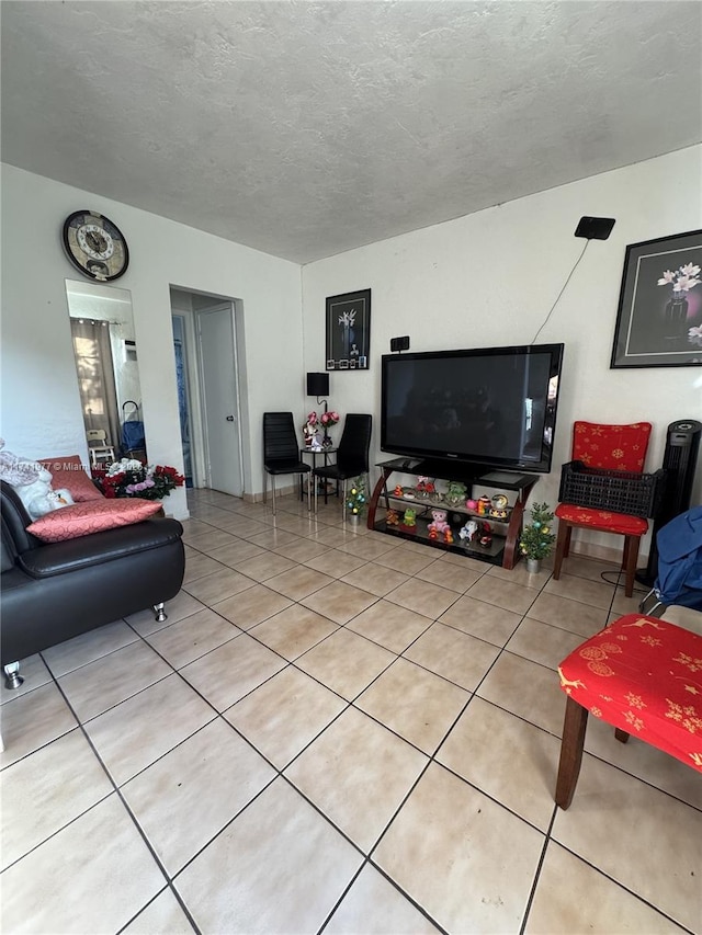 living room featuring tile patterned flooring and a textured ceiling