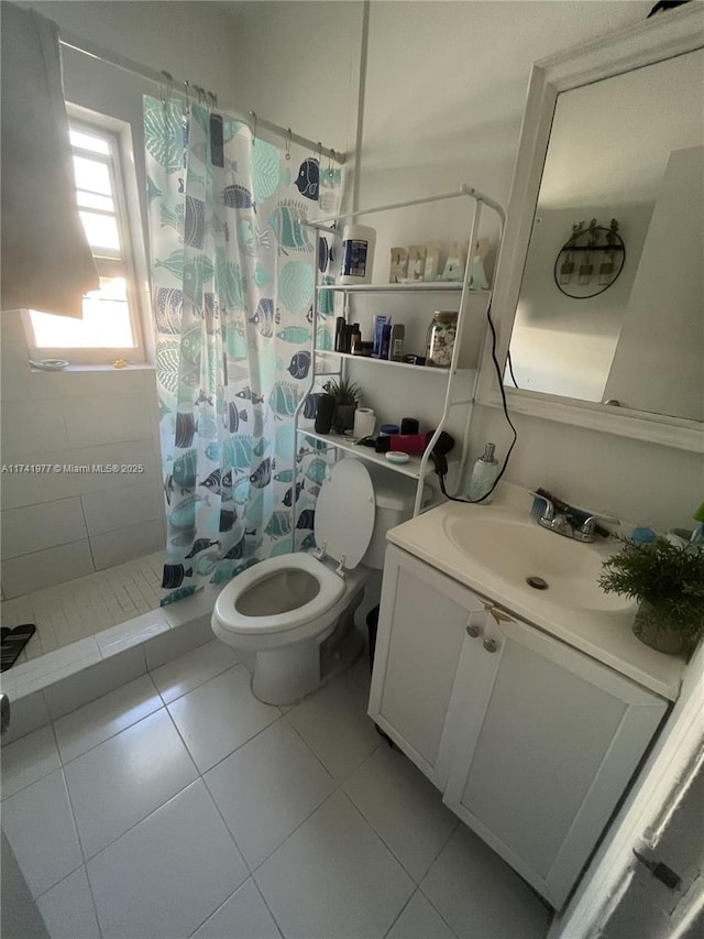 bathroom featuring toilet, vanity, tile patterned floors, and walk in shower