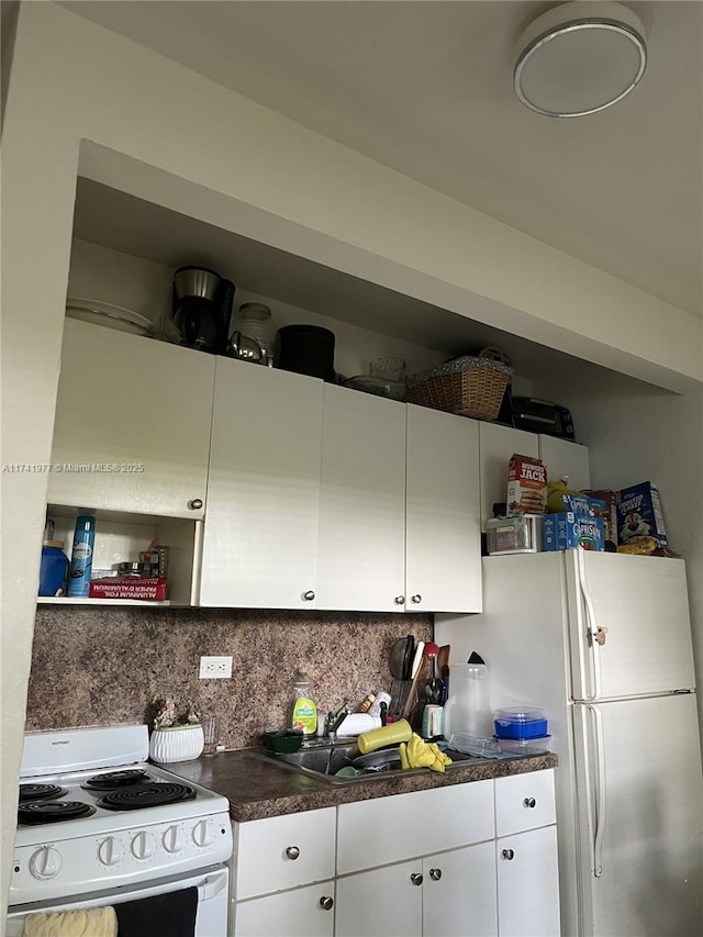 kitchen featuring backsplash, white appliances, sink, and white cabinets