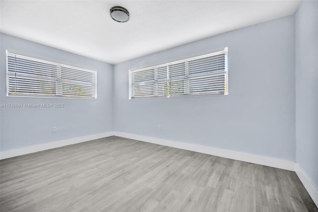 spare room with light hardwood / wood-style flooring