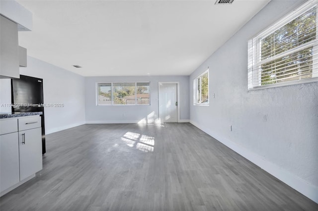 unfurnished living room with wood-type flooring