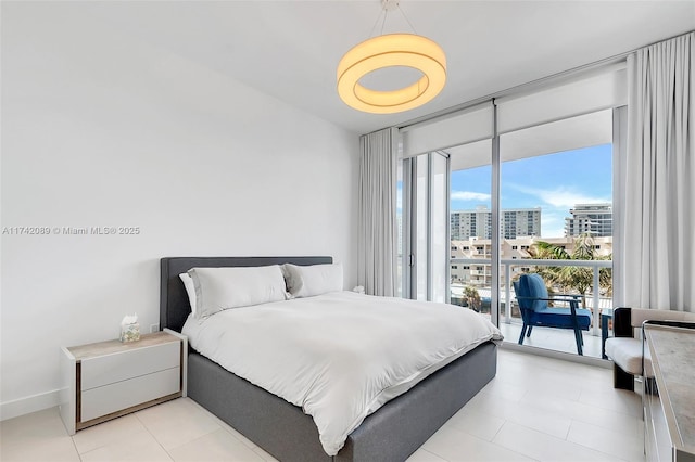 bedroom featuring floor to ceiling windows and access to exterior