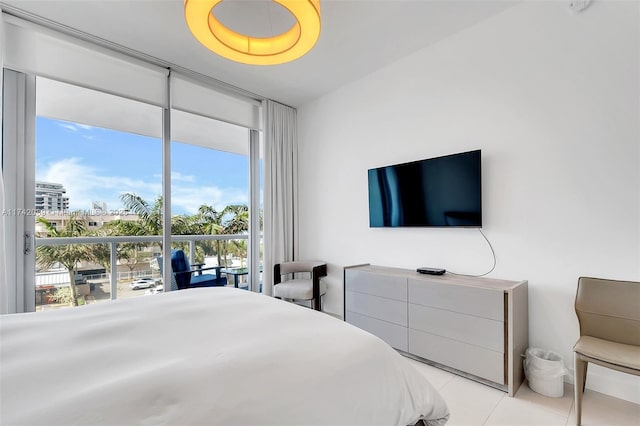 bedroom with expansive windows and light tile patterned flooring