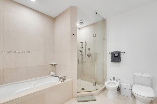 bathroom with toilet, separate shower and tub, tile walls, a bidet, and tile patterned flooring